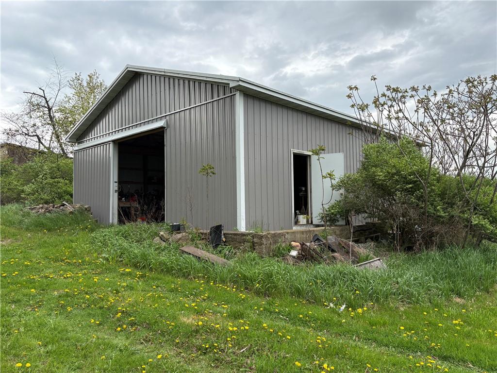609 Trout Run Road Punxsutawney, PA 15767 - Photo 29 of 34 a backyard of a house with plants and large tree