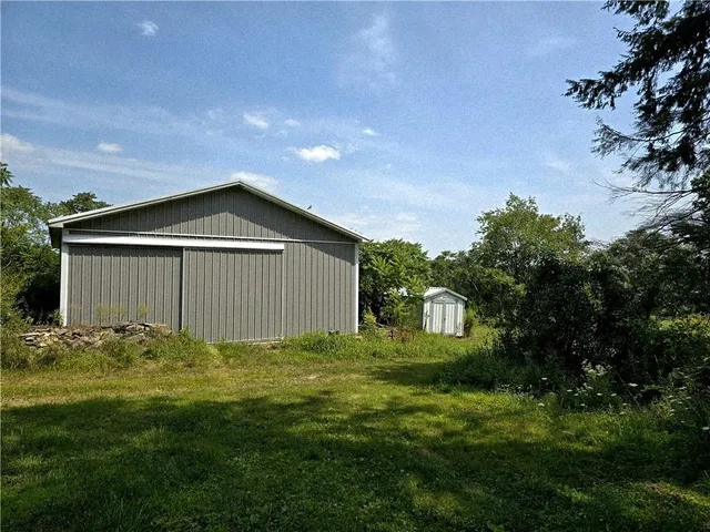 a house with green field in front of it