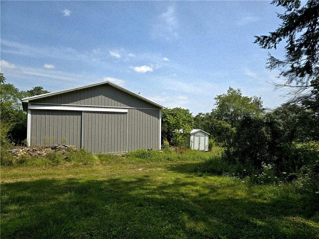 609 Trout Run Road Punxsutawney, PA 15767 - Photo 31 of 34 a house with green field in front of it