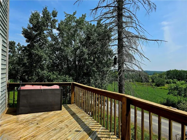 a view of balcony with wooden floor and fence