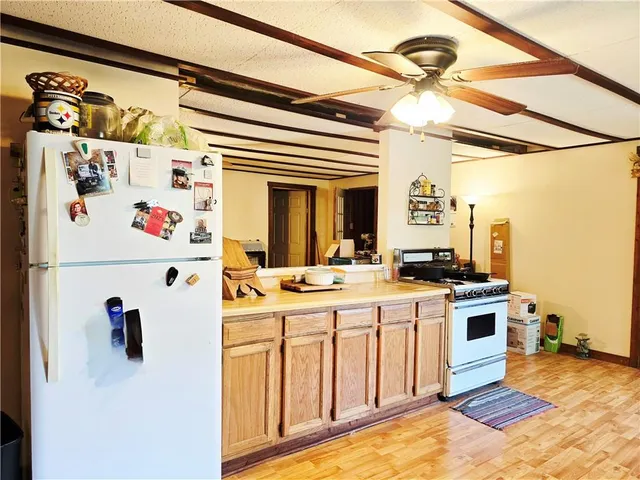 a kitchen with a stove a refrigerator and a refrigerator
