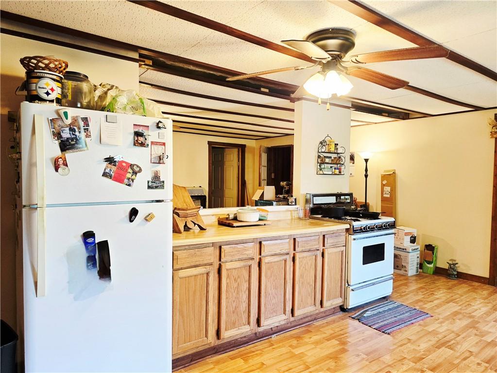 609 Trout Run Road Punxsutawney, PA 15767 - Photo 8 of 34 a kitchen with a stove a refrigerator and a refrigerator