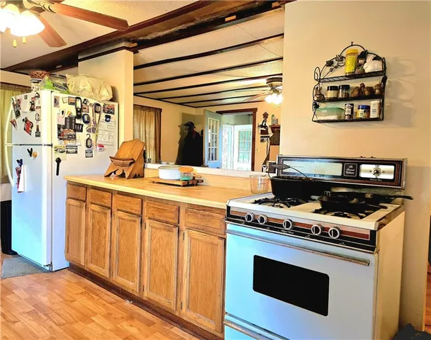 a kitchen with stainless steel appliances a stove and a microwave