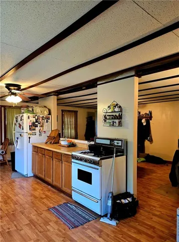 a kitchen with stainless steel appliances granite countertop a stove and a refrigerator