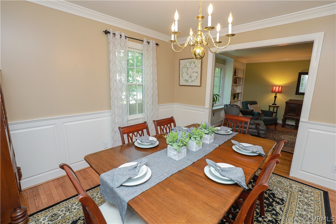 13619 Winterberry Ridge Midlothian, VA 23112 - Photo 14 of 48 a view of a dining room with furniture a rug and wooden floor