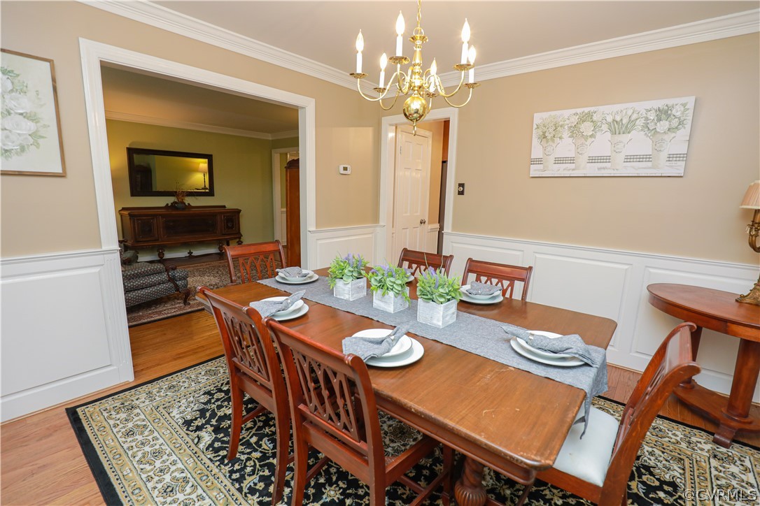 13619 Winterberry Ridge Midlothian, VA 23112 - Photo 15 of 48 a view of a dining room with furniture a rug and wooden floor