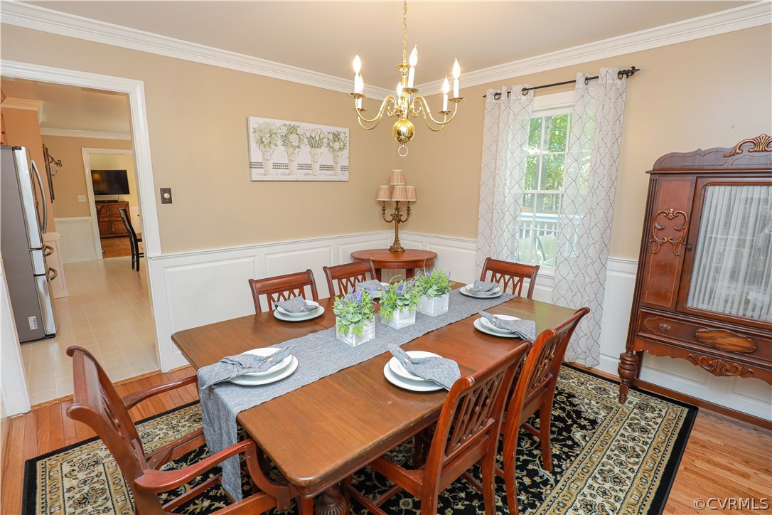 13619 Winterberry Ridge Midlothian, VA 23112 - Photo 16 of 48 a view of a dining room with furniture window and wooden floor