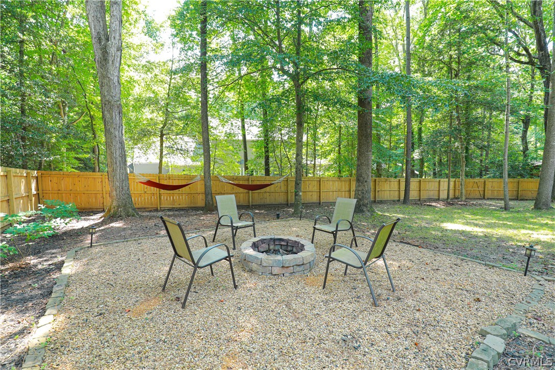 13619 Winterberry Ridge Midlothian, VA 23112 - Photo 38 of 48 a view of a backyard with table and chairs and potted plants