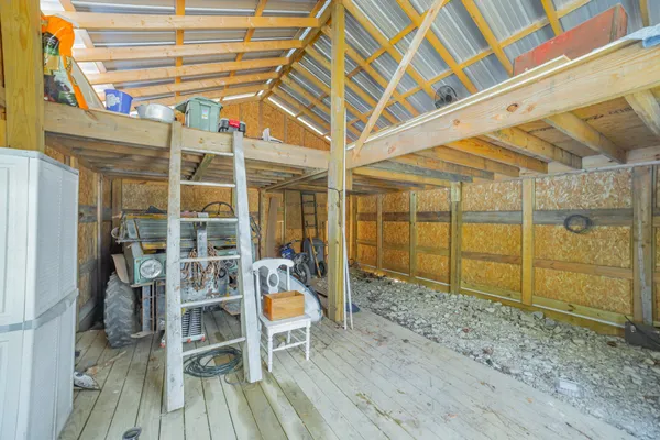 a view of a room with wooden floor and iron stairs