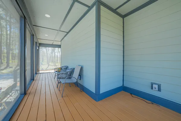 a view of a room with wooden floor and furniture