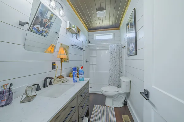 a bathroom with a sink toilet and shower