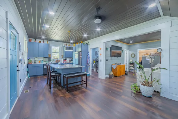 a playing room with furniture and a wooden floor