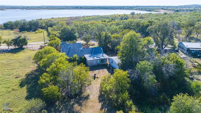 an aerial view of a city with lots of residential buildings lake and ocean view