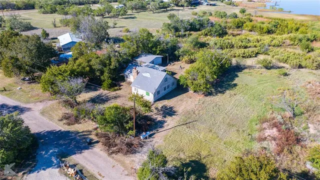 an aerial view of a houses with a lake view