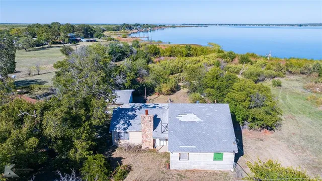 an aerial view of a house with a lake view