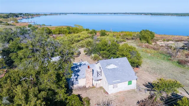an aerial view of a house with a lake view