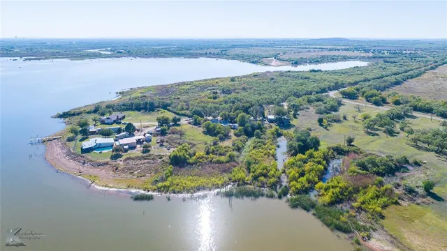 an aerial view of a house with a lake view