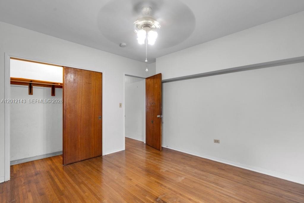 5651 Northwest 3rd Street Miami, FL 33126 - Photo 16 of 21 a view of an empty room with wooden floor and a window