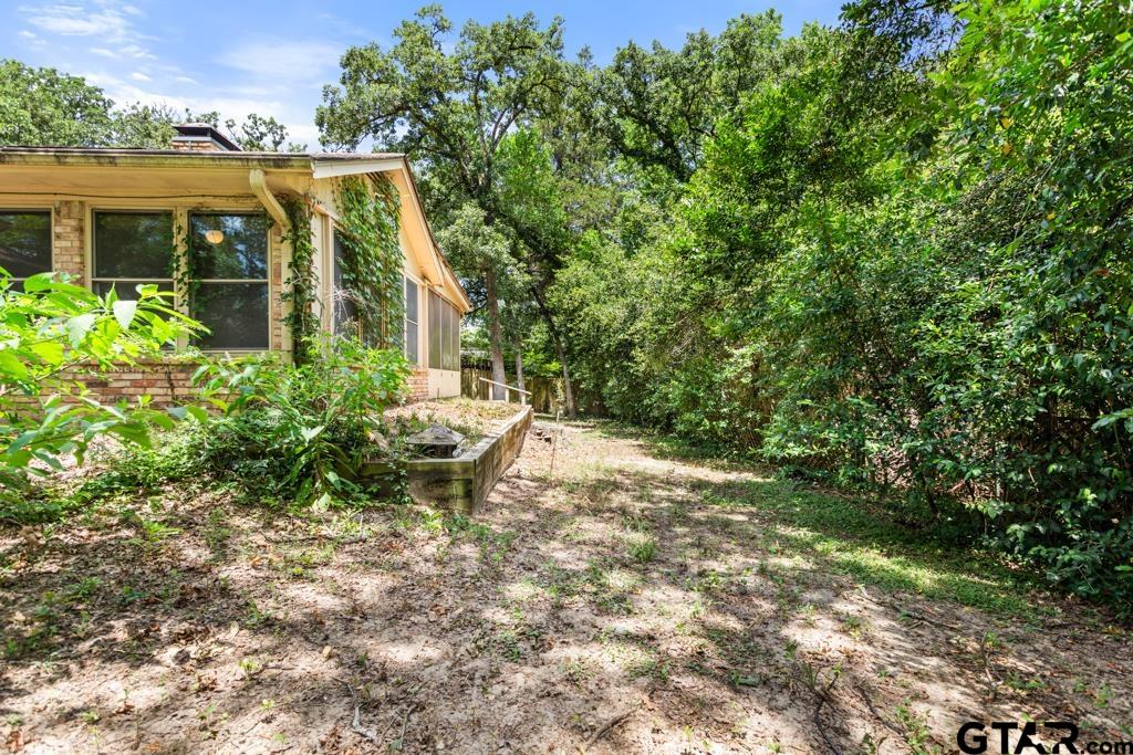 227 Brookside Drive Hideaway, TX 75771 - Photo 32 of 35 a view of a house with backyard and sitting area