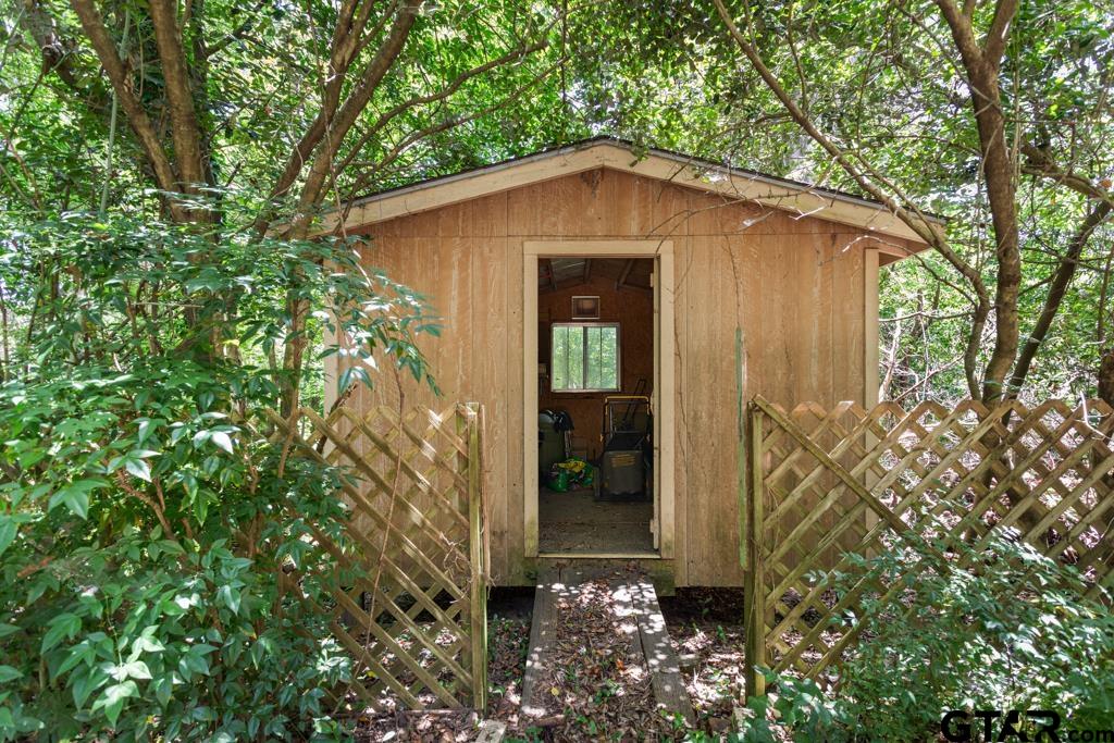 227 Brookside Drive Hideaway, TX 75771 - Photo 33 of 35 a yellow house with trees in front of it