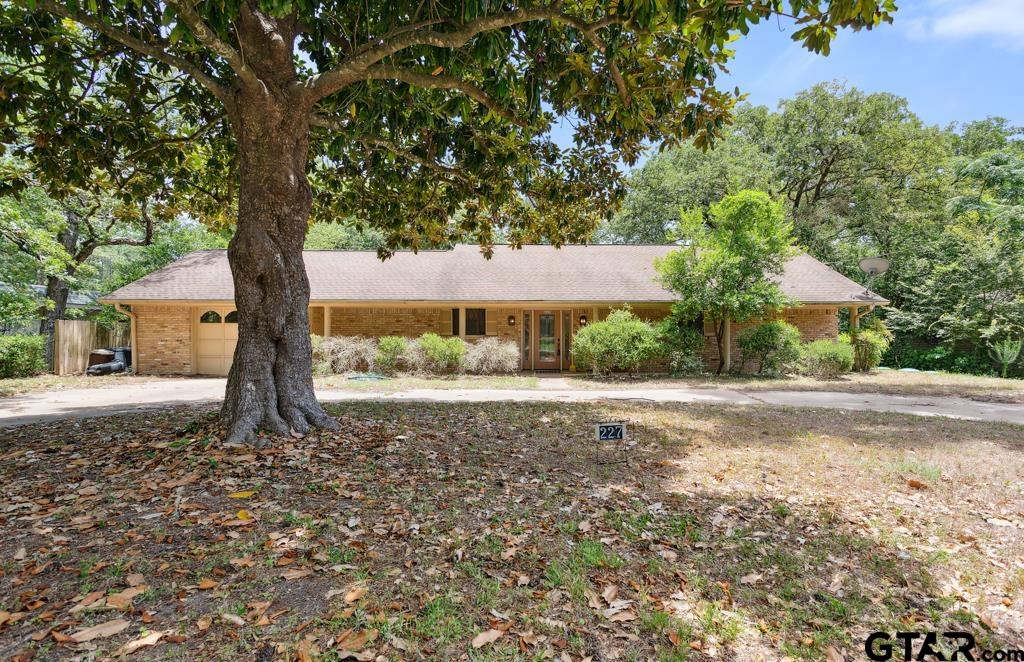 227 Brookside Drive Hideaway, TX 75771 - Photo 35 of 35 a front view of a house with a yard and garage