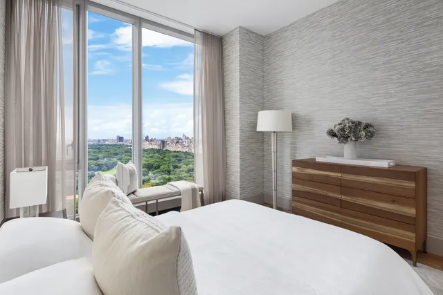 a bathroom with a granite countertop sink a mirror and shower