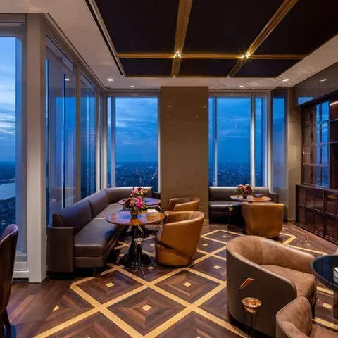 a living room with furniture and floor to ceiling windows