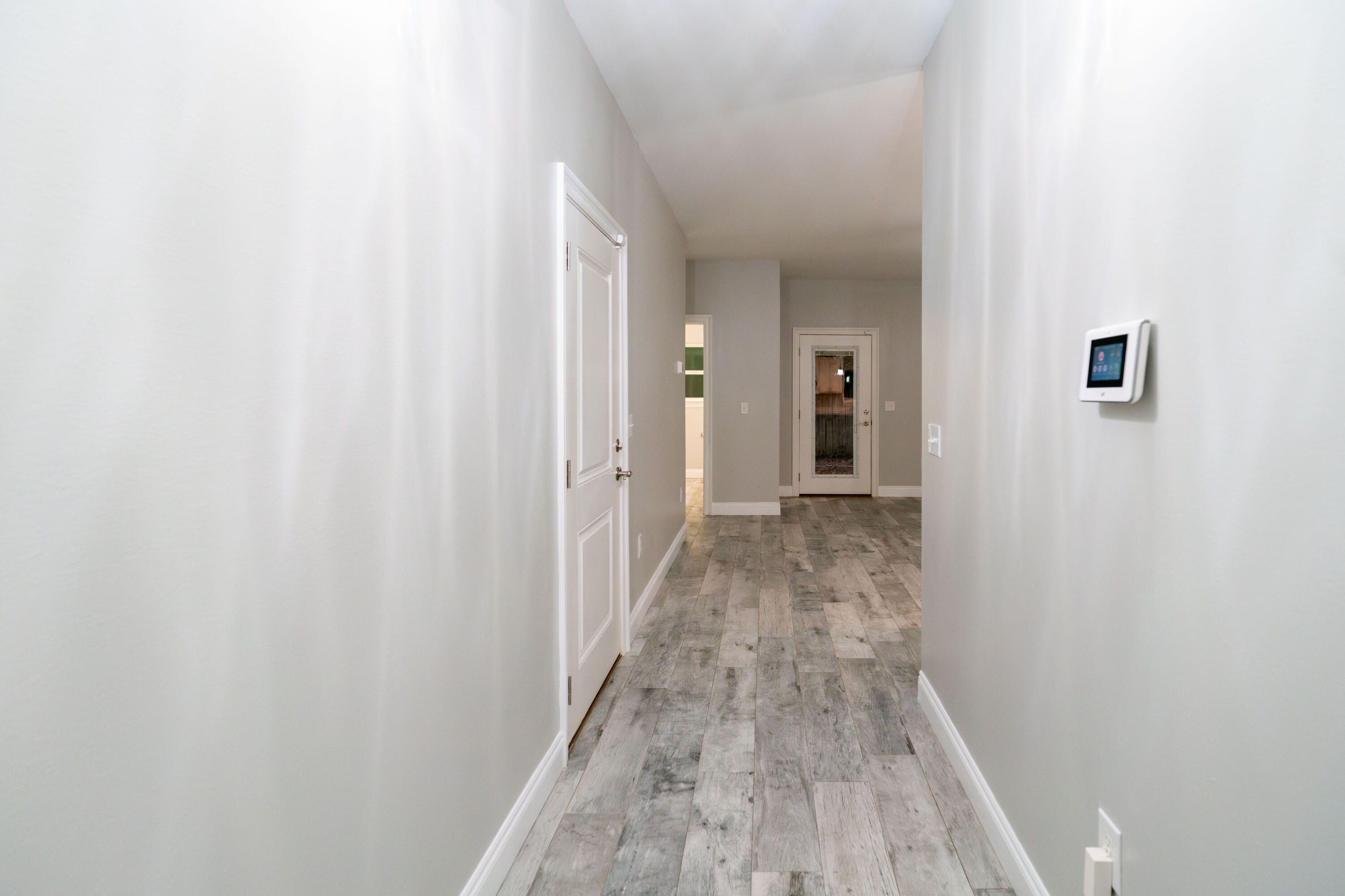 2243 Wind Trace Road North Navarre, FL 32566 - Photo 5 of 34 a view of a hallway with wooden floor