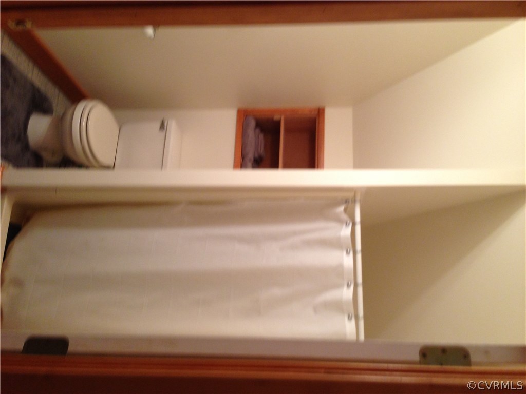 2309 Mt Pleasant Road Pamplin, VA 23958 - Photo 11 of 16 a bathroom with a toilet and a shower curtain