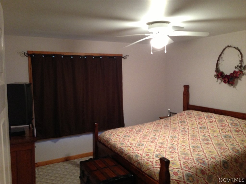 2309 Mt Pleasant Road Pamplin, VA 23958 - Photo 7 of 16 a bedroom with a bed and a chandelier