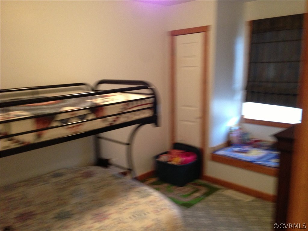 2309 Mt Pleasant Road Pamplin, VA 23958 - Photo 8 of 16 a room with a bed and a lamp on dresser