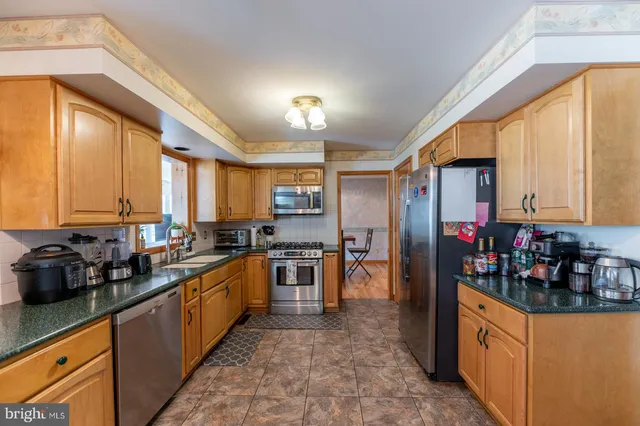 a view of a kitchen with a stove top oven and refrigerator
