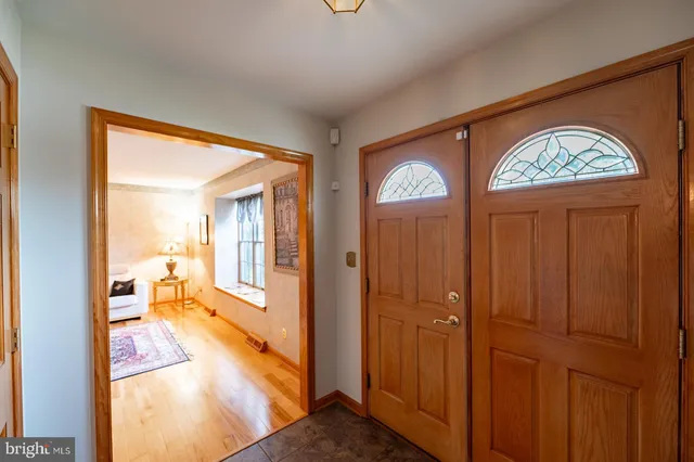 a living room with furniture a rug a lamp and a window