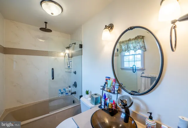 a view of walk in closet with clothes