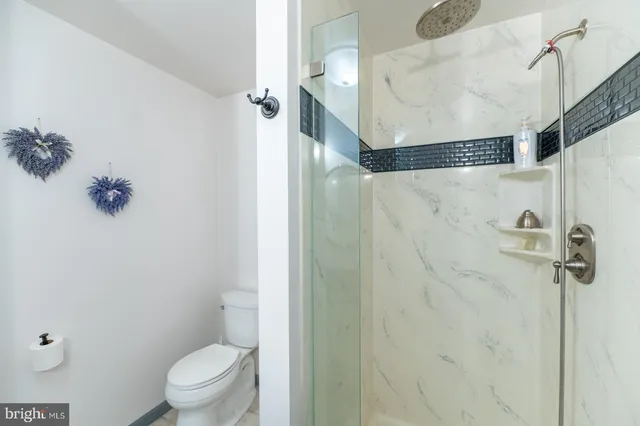 a couple of chairs sitting in a backyard with large trees