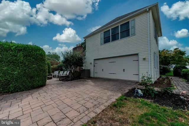a front view of a house with garden and porch