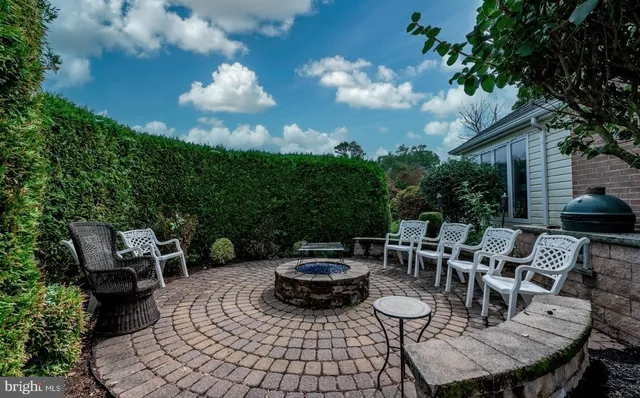 a view of a house with a big yard and large trees