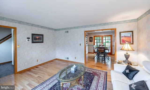 a view of a dining room with furniture a chandelier and wooden floor