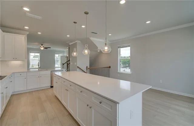a large white kitchen with a large window