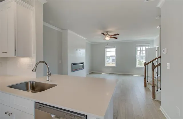 a kitchen with a sink cabinets and window