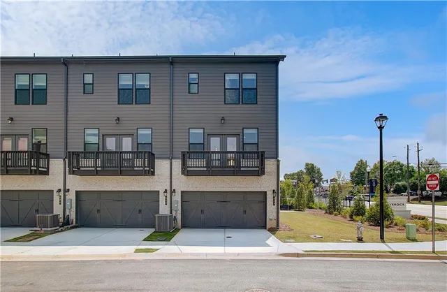 a view of a brick house with a yard