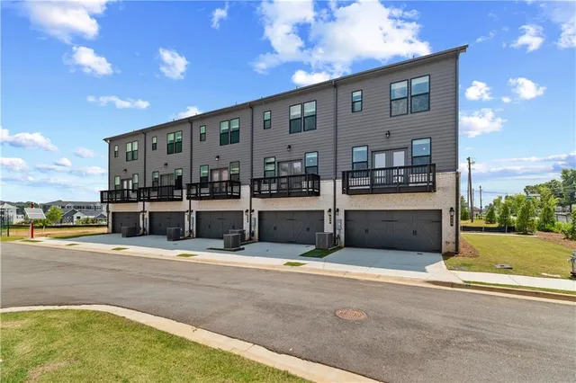 a front view of a building with a garden