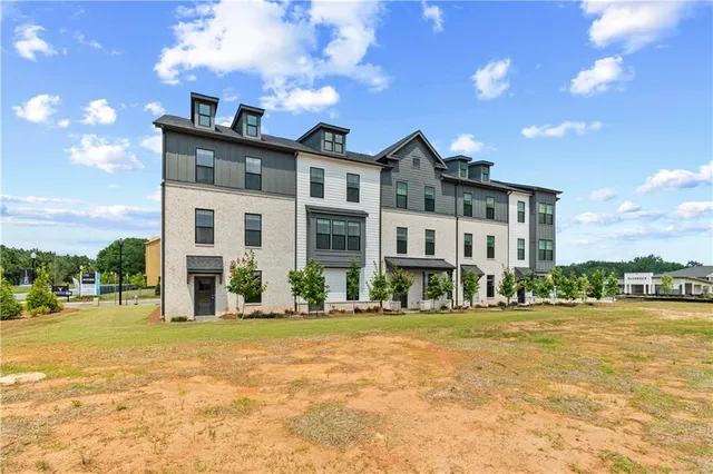 a front view of a building with a garden