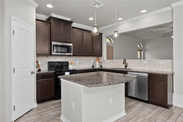 a kitchen with a sink stove and refrigerator