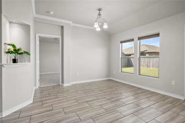 an empty room with windows and entrance