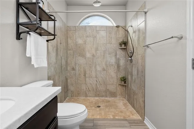a bathroom with a toilet a sink and shower