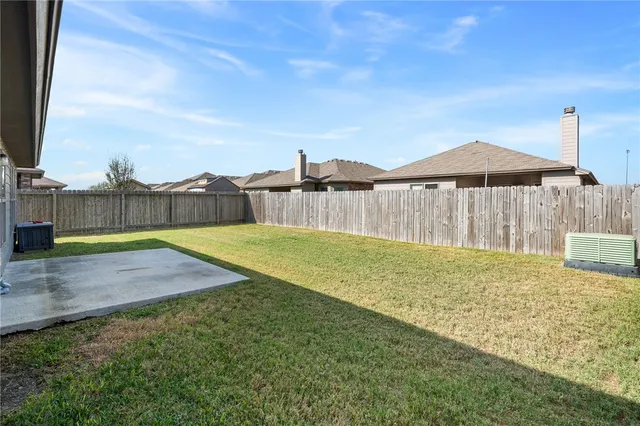 a view of a backyard with swimming pool