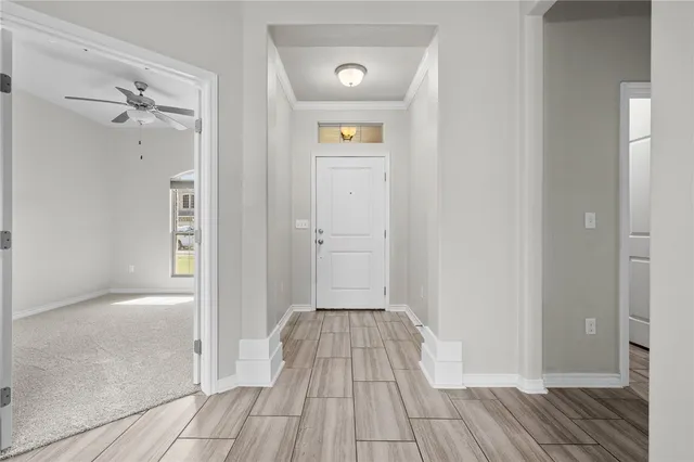a view of a hallway with wooden floor
