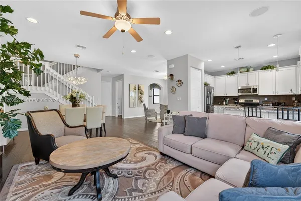 a living room with furniture and kitchen view