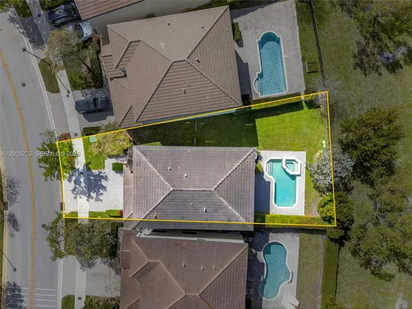 an aerial view of a house with a yard and a fountain